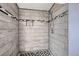 Bathroom features a remodeled walk-in shower with gray-wood like tile and accents at 130 Elm St, Hudson, CO 80642