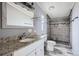 Bathroom features a new vanity with stone countertop and remodeled walk-in shower at 130 Elm St, Hudson, CO 80642