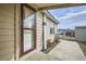 Exterior angle shot featuring tan home elevation with front window, door, and sidewalk at 130 Elm St, Hudson, CO 80642