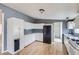 View of the kitchen features white cabinets, a black refrigerator, and an outdated look at 130 Elm St, Hudson, CO 80642