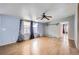 View of the open living room with light wood flooring, neutral paint, and bright windows at 130 Elm St, Hudson, CO 80642