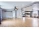 View of the open concept living room and kitchen with light wood flooring and neutral paint at 130 Elm St, Hudson, CO 80642