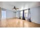 Spacious living room boasts light wood flooring, natural light, and a ceiling fan at 130 Elm St, Hudson, CO 80642