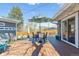 Outdoor deck features a dining table with seating, string lights and an umbrella for shade at 1325 S Ivy Way, Denver, CO 80224