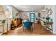 Dining room featuring natural light, a modern table setting, and inviting wood floors at 1325 S Ivy Way, Denver, CO 80224