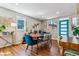 Dining room features a stylish table setting, wood floors, and bright windows, ideal for gatherings at 1325 S Ivy Way, Denver, CO 80224