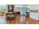 Inviting living room with hardwood floors, a stylish console table, and a blue accent door at 1325 S Ivy Way, Denver, CO 80224