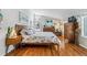 Bright bedroom featuring hardwood floors, modern decor, and large windows for natural light at 1325 S Ivy Way, Denver, CO 80224