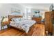 Bright bedroom featuring hardwood floors, modern decor, and large windows for natural light at 1325 S Ivy Way, Denver, CO 80224