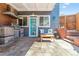 Covered outdoor kitchen featuring a built-in grill, ample seating, and stone accents at 1325 S Ivy Way, Denver, CO 80224