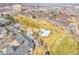 Aerial view of a townhome community near a golf course, capturing a panoramic perspective of green fairways and surroundings at 2733 W Greens Ln, Littleton, CO 80123