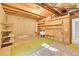 Unfinished basement featuring an open ceiling with exposed beams, offering ample space for customization and storage at 2733 W Greens Ln, Littleton, CO 80123