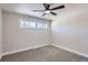 Simple bedroom with ceiling fan and neutral wall paint at 1040 Hoover Ave, Fort Lupton, CO 80621