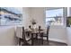 Cozy breakfast nook with a dark wood table and two chairs, near a window at 1040 Hoover Ave, Fort Lupton, CO 80621