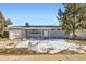 Newly remodeled home with a gray exterior, white door, and attached garage at 1040 Hoover Ave, Fort Lupton, CO 80621