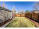 Lush backyard featuring a green lawn, privacy fence, and mature trees offering shade at 860 Magnolia St, Denver, CO 80220