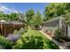 Backyard featuring lush lawn, greenery, and fencing at 860 Magnolia St, Denver, CO 80220
