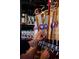 Close up of a bartender pouring beer from wooden Denver Beer Co. taps, with glassware visible on shelves behind at 860 Magnolia St, Denver, CO 80220
