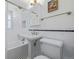 Bathroom featuring white subway tiles, black accent tile, pedestal sink and black and white tile floor at 860 Magnolia St, Denver, CO 80220