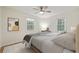 Bright bedroom with neutral tones, ceiling fan, two windows, and an accent painting at 860 Magnolia St, Denver, CO 80220
