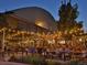 Outdoor beer garden with string lights, wooden picnic tables, and a lively atmosphere at 860 Magnolia St, Denver, CO 80220