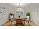 Cozy dining room with a wooden table and chairs, complemented by a stylish overhead light fixture at 860 Magnolia St, Denver, CO 80220