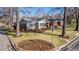 Well-maintained home with mature trees, tidy landscaping, and a neatly manicured front lawn at 860 Magnolia St, Denver, CO 80220