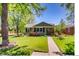 Charming single-story home with a well-kept lawn and garden beds in a sunny setting at 860 Magnolia St, Denver, CO 80220