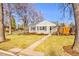 Lovely single-story home featuring mature trees, a well-kept lawn, and appealing curb appeal at 860 Magnolia St, Denver, CO 80220