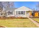 Charming single-story home with a well-kept lawn, garden beds, and classic architectural details at 860 Magnolia St, Denver, CO 80220