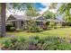 Charming home featuring a well-manicured front yard with colorful flower beds and mature trees at 860 Magnolia St, Denver, CO 80220