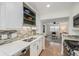 Stylish kitchen with white cabinets, stainless appliances, and an open layout to the living area at 860 Magnolia St, Denver, CO 80220