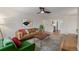 Comfortable living room with hardwood floors, a cozy sofa, and a view into the adjoining kitchen at 860 Magnolia St, Denver, CO 80220