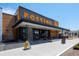 Exterior view of Postino with outdoor seating, large signage, and a modern facade at 860 Magnolia St, Denver, CO 80220