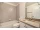 Bathroom features a shower over tub with a gray tiled backsplash and a vanity sink at 2032 S Holly St # 3, Denver, CO 80222