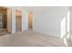 Bright bedroom features plush carpet with access to a closet and bathroom at 2032 S Holly St # 3, Denver, CO 80222