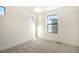 This bright bedroom features plush carpet and a window for natural light at 2032 S Holly St # 3, Denver, CO 80222