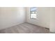 Bright bedroom features plush carpet and a large window for natural light at 2032 S Holly St # 3, Denver, CO 80222