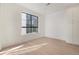 Bright bedroom with large window, hardwood floors, and built-in white cabinets at 2032 S Holly St # 3, Denver, CO 80222