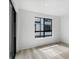 Cozy bedroom featuring light wood floors and a large window for ample natural light at 2032 S Holly St # 3, Denver, CO 80222
