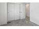 Bedroom features a closet with sliding doors and neutral carpet at 2032 S Holly St # 3, Denver, CO 80222