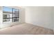 Bright bedroom features plush carpet, natural light and a large window at 2032 S Holly St # 3, Denver, CO 80222