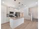 Modern kitchen featuring island, stainless steel appliances, and hardwood flooring at 2032 S Holly St # 3, Denver, CO 80222