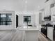 Bright kitchen with white cabinets, quartz countertops, stainless appliances, and large windows at 2032 S Holly St # 3, Denver, CO 80222