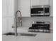 Modern kitchen features a stainless steel sink and faucet against the backdrop of modern appliances at 2032 S Holly St # 3, Denver, CO 80222