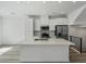 Modern kitchen featuring white cabinets, quartz countertops, and stainless steel appliances at 2032 S Holly St # 3, Denver, CO 80222