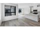 Bright kitchen with white cabinets, quartz countertops, stainless appliances, and large windows at 2032 S Holly St # 3, Denver, CO 80222