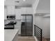 Bright kitchen features stainless steel appliances, white cabinets, and quartz countertops at 2032 S Holly St # 3, Denver, CO 80222