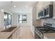 Modern kitchen showcasing stainless steel appliances, large sink and island counter space at 2032 S Holly St # 3, Denver, CO 80222