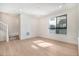 Bright and spacious living room featuring hardwood floors, large window, and modern finishes at 2032 S Holly St # 3, Denver, CO 80222